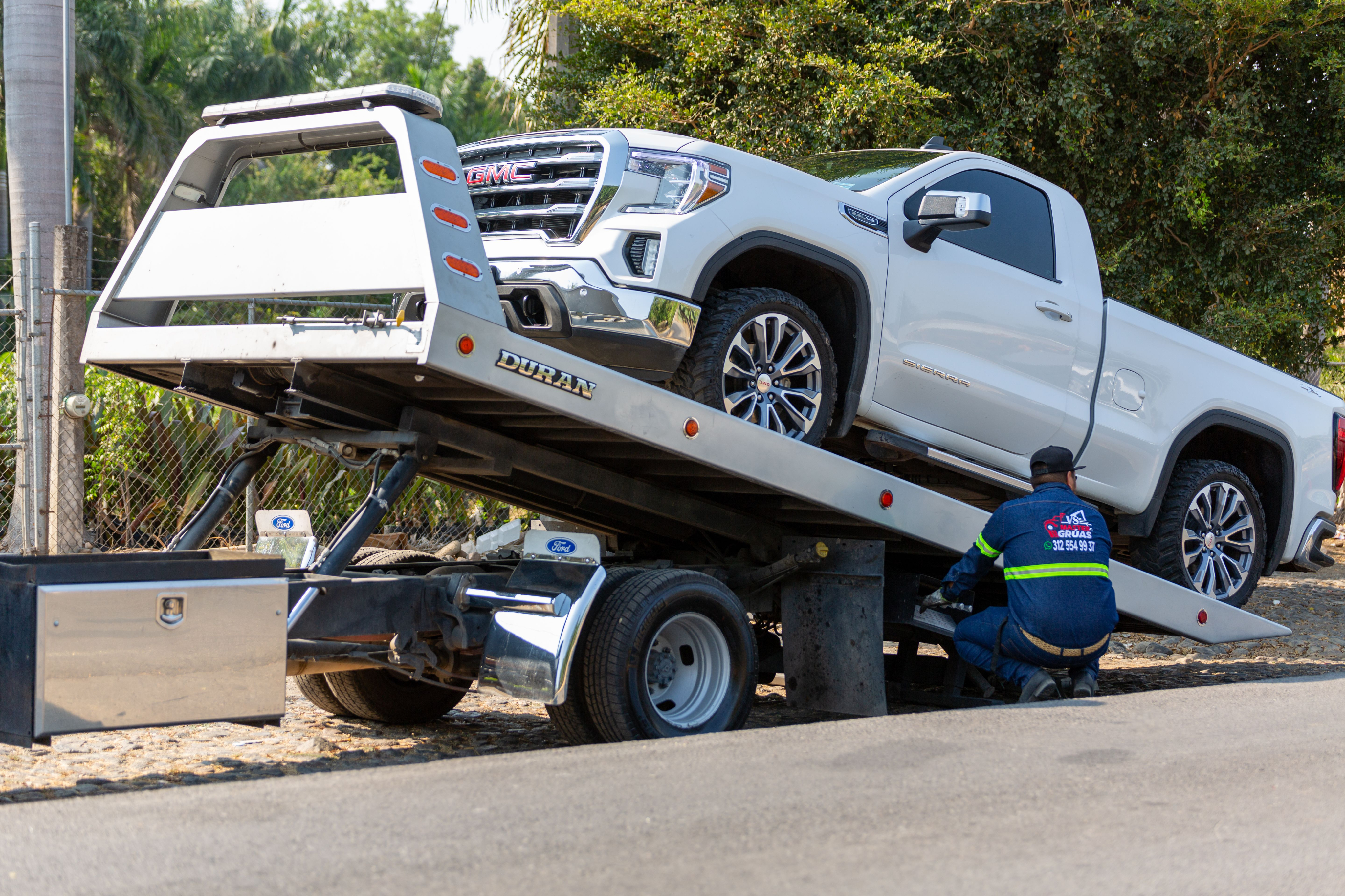 Vehicle being loaded onto a transport trailer